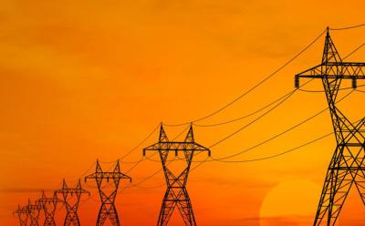 Electric power transmission lines over sunrise