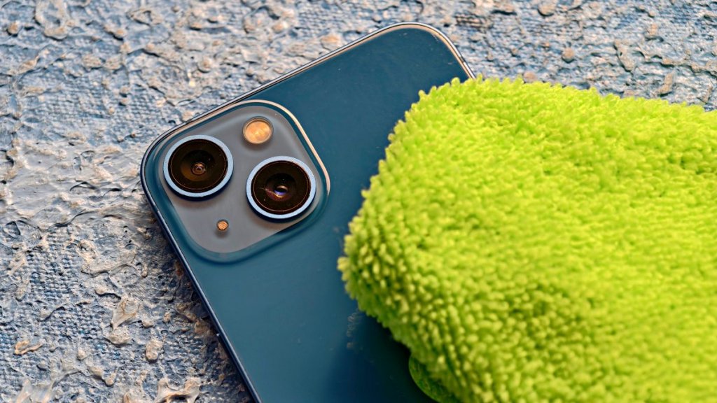 Cleaning iPhone camera lens with a soft cloth