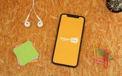 Amazon Pay on an iPhone placed on an orange background