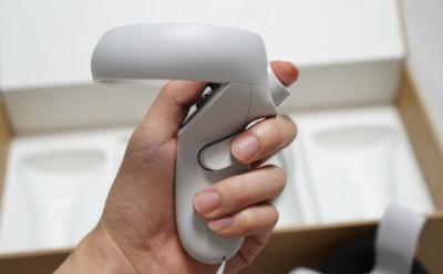 An image showcasing a hand holding the Meta Quest 2 controller
