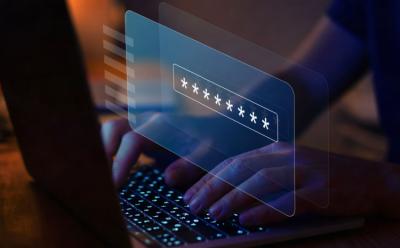 This image depicts the act of typing password on a laptop