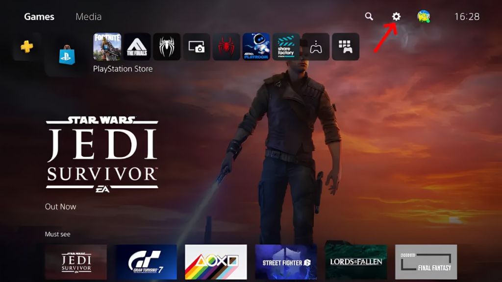PlayStation 5 home screen with a red arrow pointing towards the settings