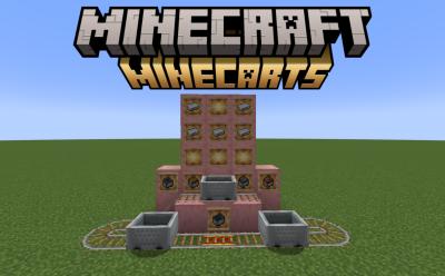 Connected rails and powered rails with several minecarts on top and solid blocks with item frames holding iron ingots and minecart variants in Minecraft