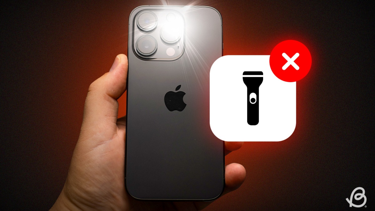 shot of a hand holding an iPhone with the flashlight working