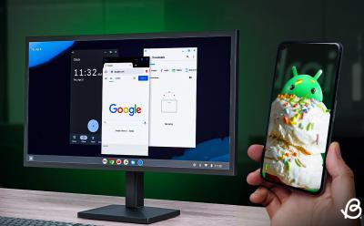 illustration showing the desktop mode on Android on a monitor with a hand holding a phone next to it