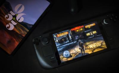 Steam deck with a a tablet and the game saboteur running