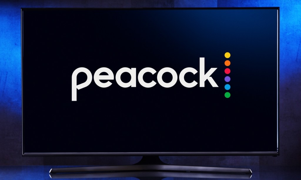 shot of a TV displaying the Peacock logo in front of a dark blue gradient background