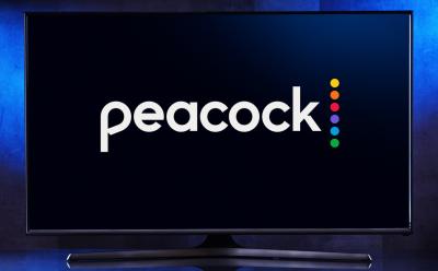 shot of a TV displaying the Peacock logo in front of a dark blue gradient background