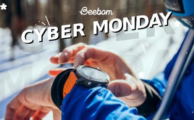 man interacting with a smartwatch worn on wrist in a snowy backdrop with Cyber Monday text at the top