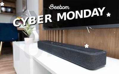 Soundbar in a modern home living room placed on a desk under the TV with Cyber Monday text at the top