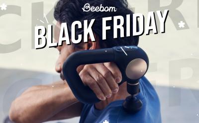 Man using TheraGun Sense on their back with Black Friday text at the top