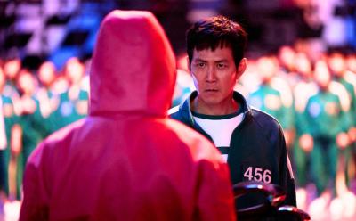 Gi Hun facing a guard in a still from Squid Game Season 2
