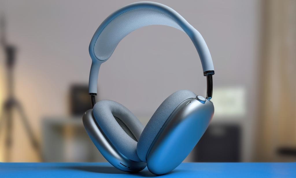 shot of the Apple AirPods Max placed on a blue flat surface with a blurred background