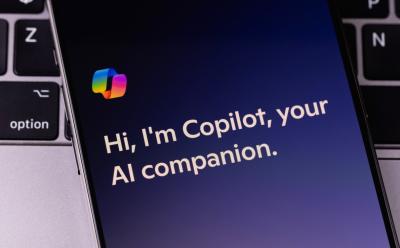 shot of a phone placed on top of a laptop keyboard with Copilot app open
