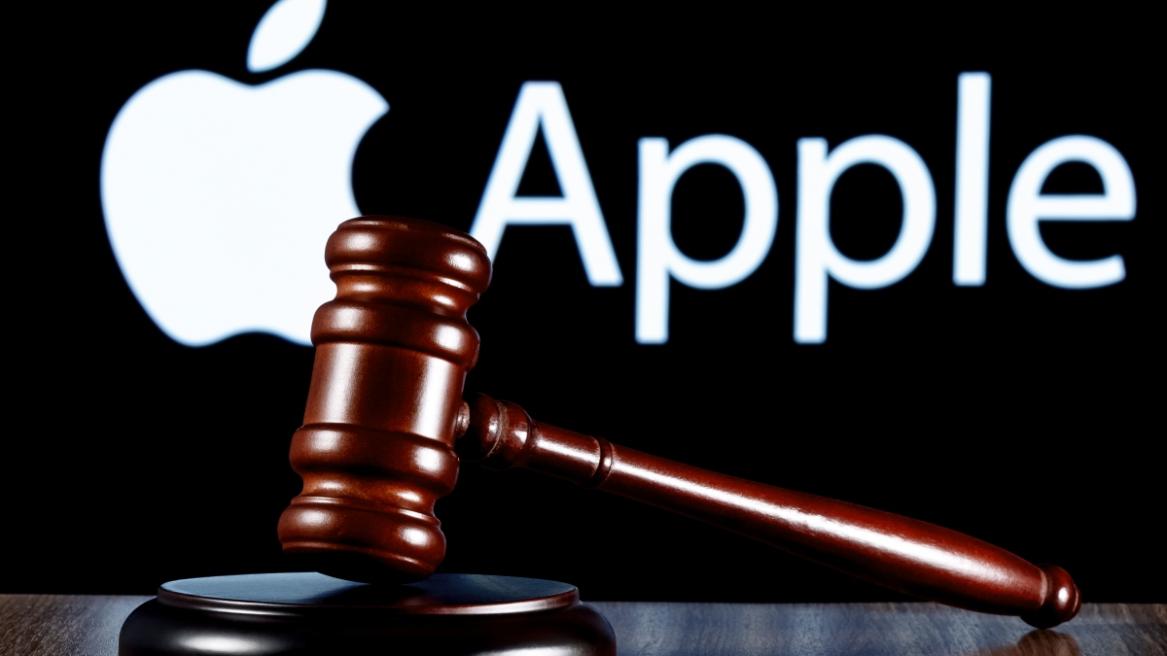 Gavel on table against the background of Apple company logo.