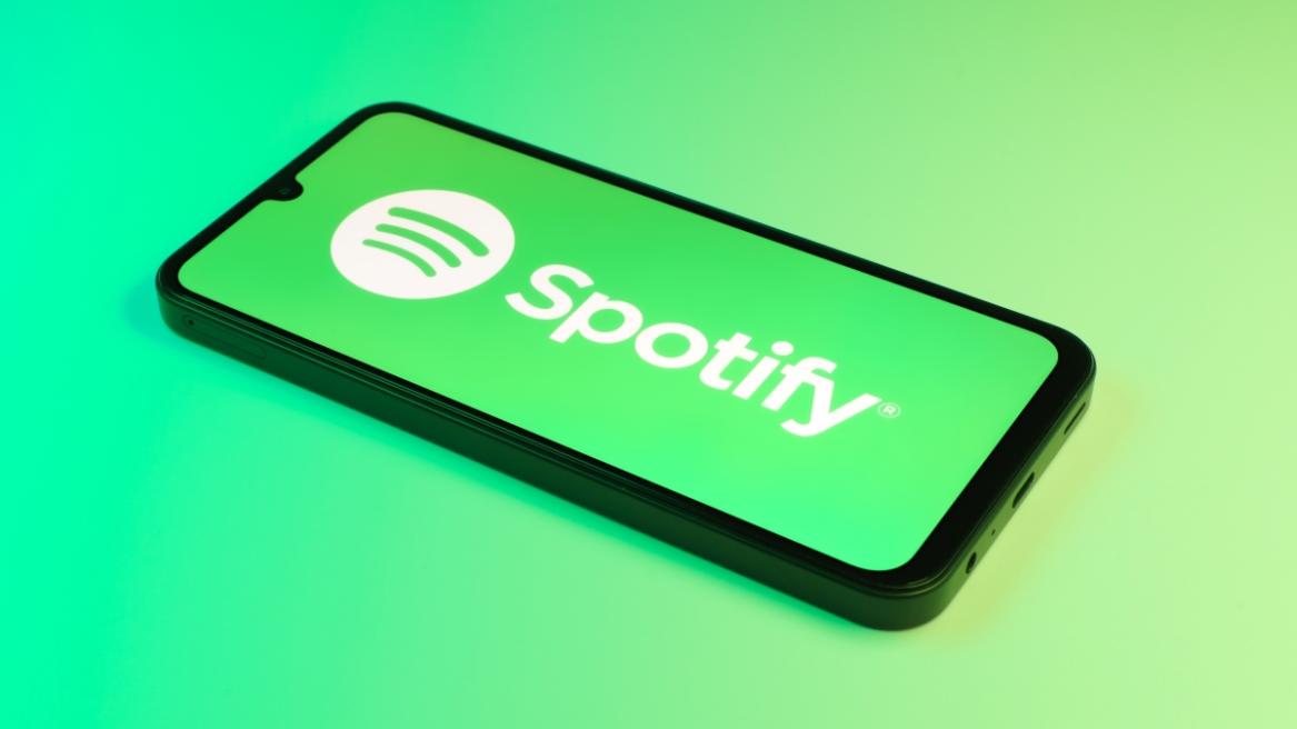 Smartphone on surface showing Spotify logo