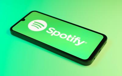 Smartphone on surface showing Spotify logo