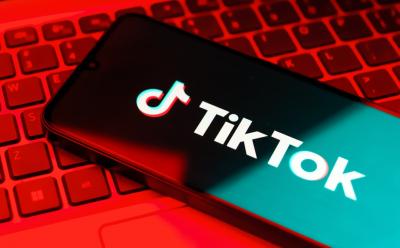 TikTok open on a phone laying on a keyboard
