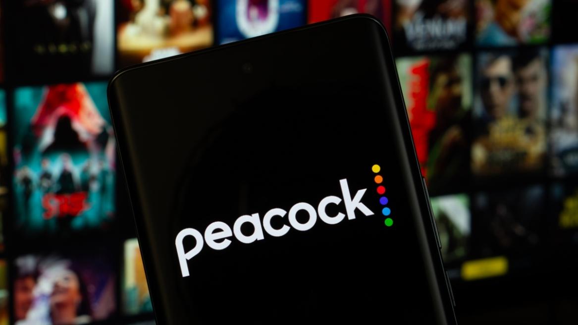 The logo of the peacock is displayed on a smartphone screen, and the website peacock is visible on a computer screen in the background.