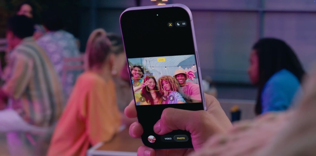 Taking a group selfie using the Center Stage front camera in iPhone 17