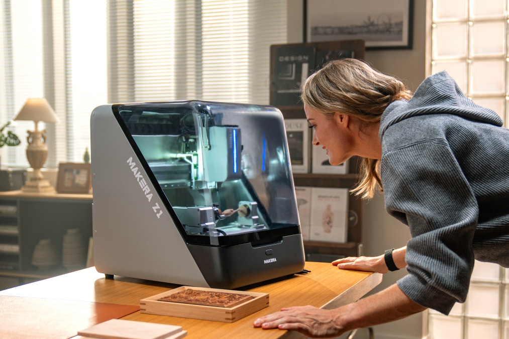 A Lady looking into the Makera Z1 CNC machine
