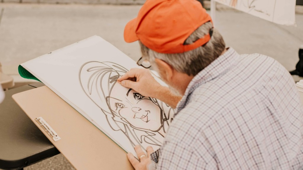 Photo of man drawing a caricature 