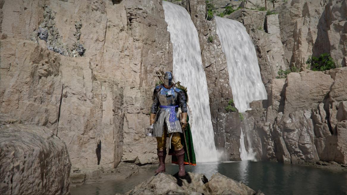 Kliff standing in front of a waterfall