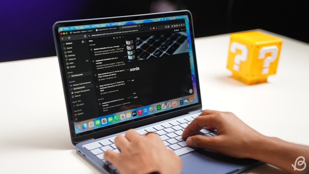 MacBook Neo working on it with multiple screens open 