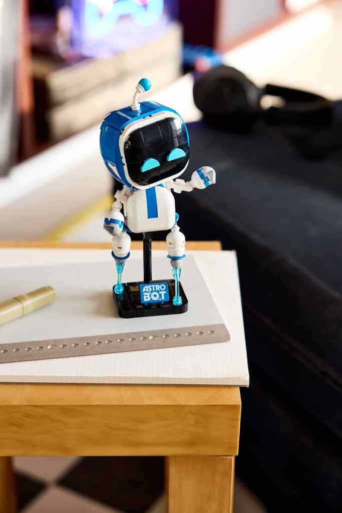 LEGO Astro Bot posing on a tabletop.