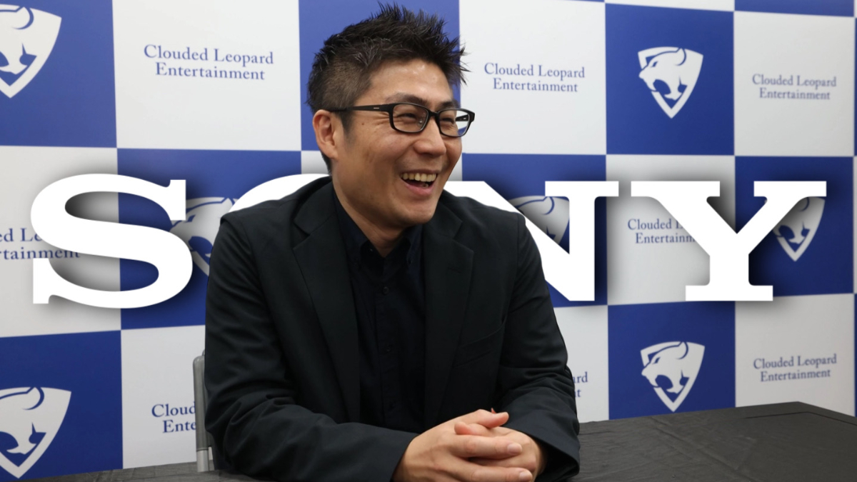 NIS America president Kenzo Saruhashi in an interview with the Sony logo in the background.